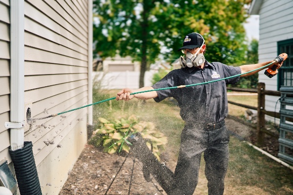 employee cleaning dryer vent